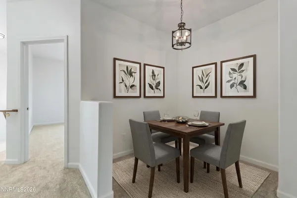 a view of a dining room with a table and chairs