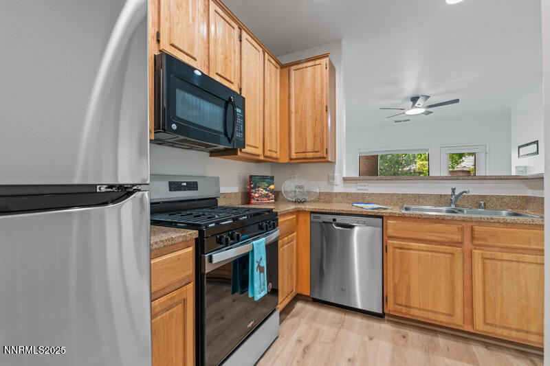 900 South Meadows Parkway, Unit 3322 Reno, NV 89521 - Photo 7 of 35 a kitchen with stainless steel appliances granite countertop a stove a sink and a microwave