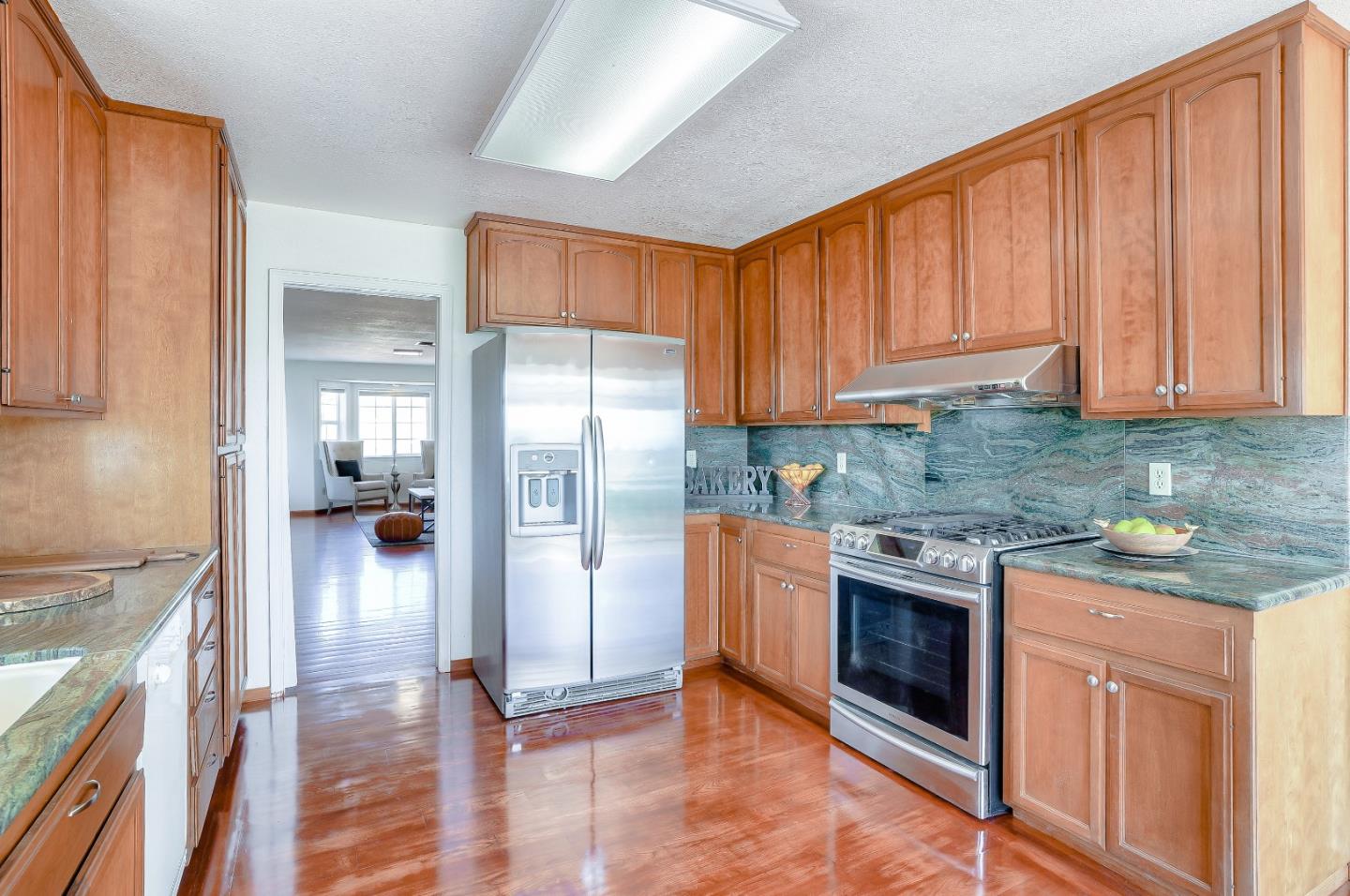 2800 Roop Road Gilroy, CA 95020 - Photo 18 of 70 a kitchen with stainless steel appliances granite countertop a stove a refrigerator and a stove top oven