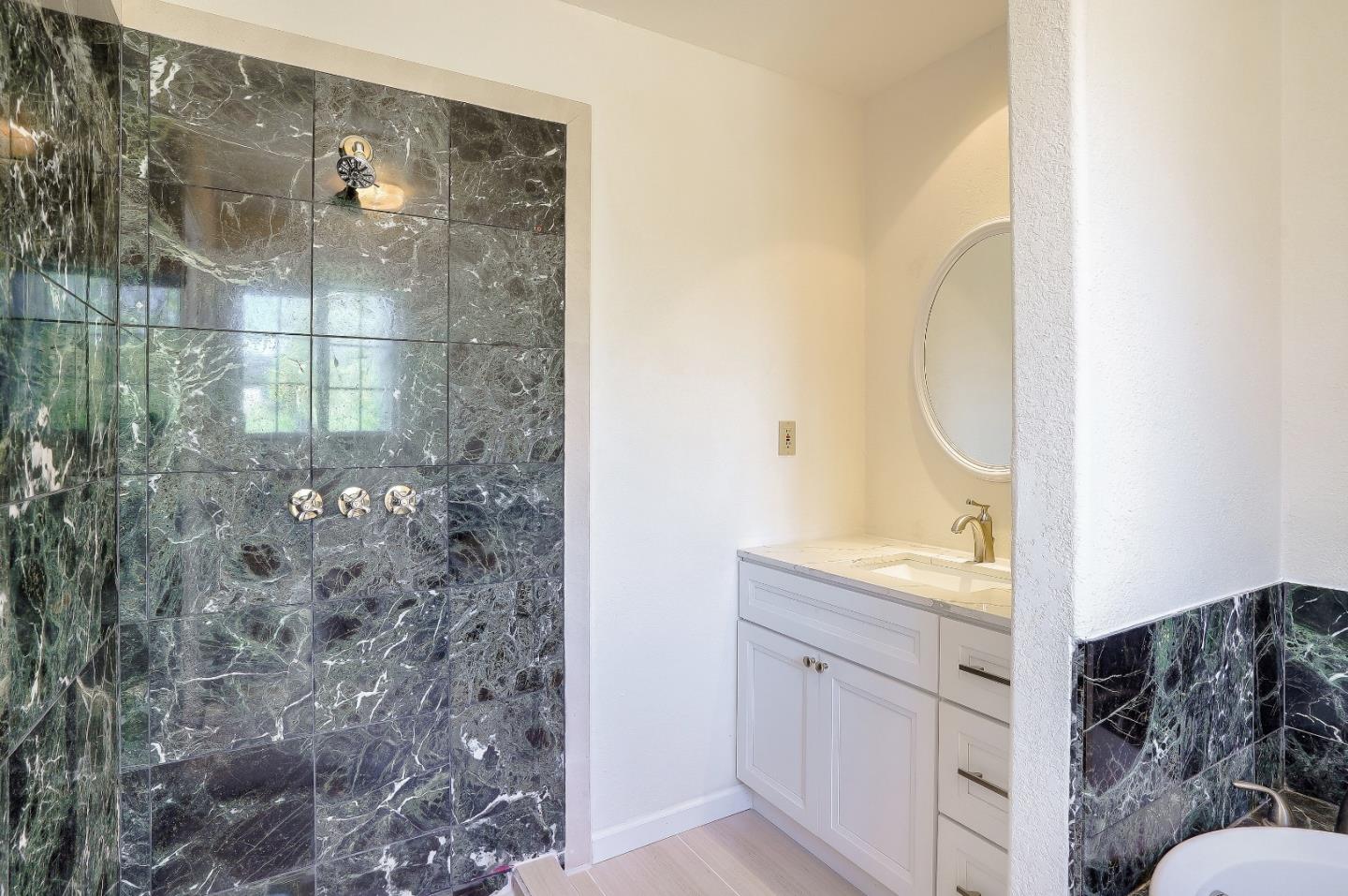 2800 Roop Road Gilroy, CA 95020 - Photo 32 of 70 a bathroom with a sink and a mirror