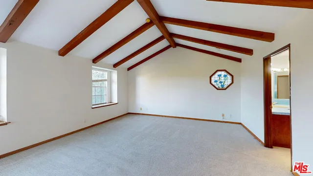 a view of a room with window and a ceiling fan