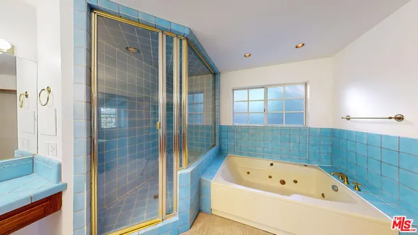 a bathroom with a bathtub and a shower
