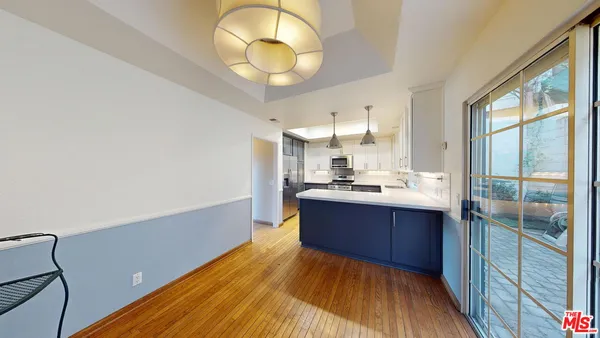 a view of kitchen with sink and wooden floor