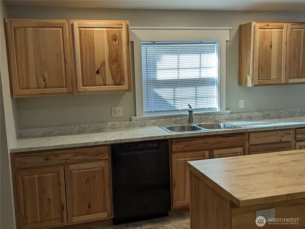 a kitchen with a sink and cabinets