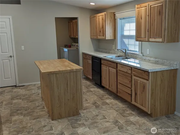 a kitchen with sink cabinets and window