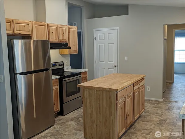 a kitchen with a refrigerator sink and stove