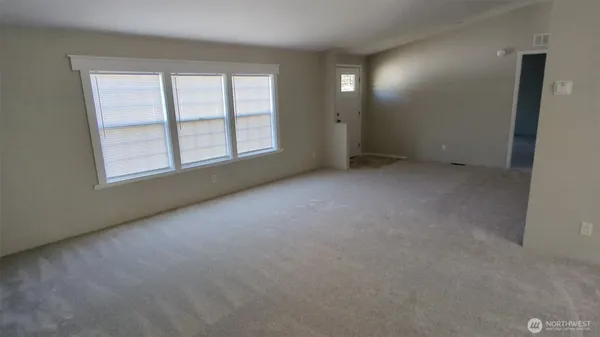 an empty room with windows and closet