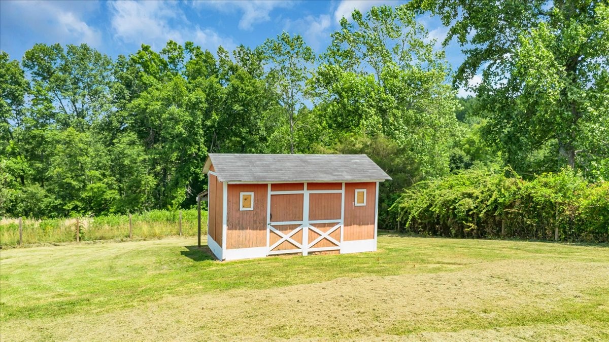2657 Oak Grove Road Red Boiling Springs, TN 37150 - Photo 39 of 45 a view of a house with a backyard and a tree