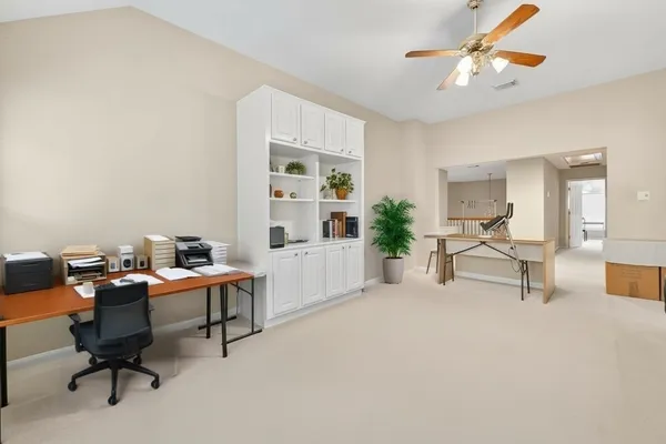 a work room with furniture and a potted plant