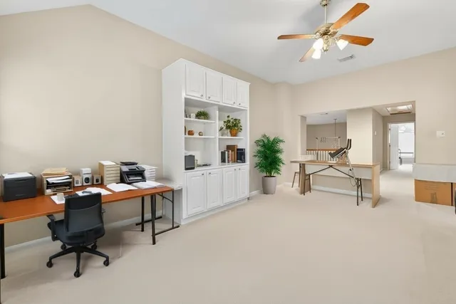 a work room with furniture and a potted plant