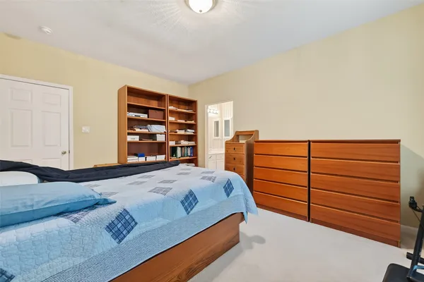 a bedroom with a bed and a dresser