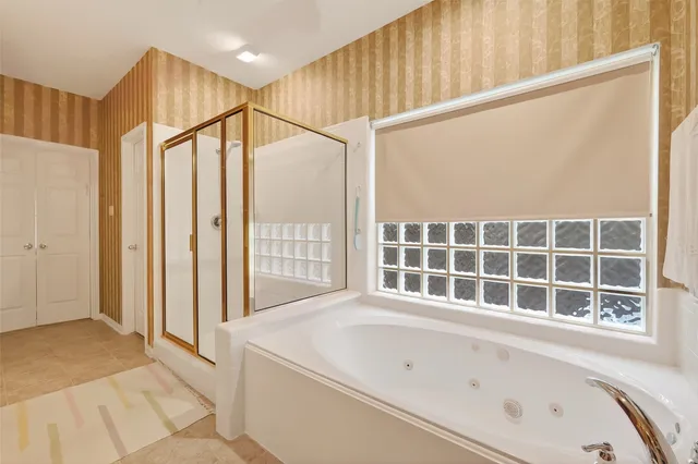 a bathroom with a bathtub and a window