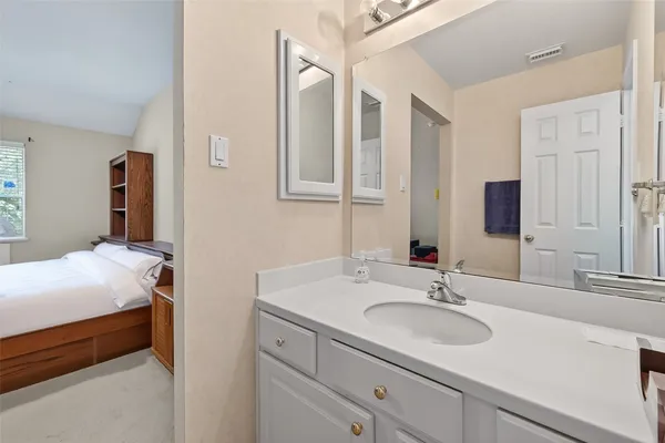 a en suite bathroom with a sink and a mirror