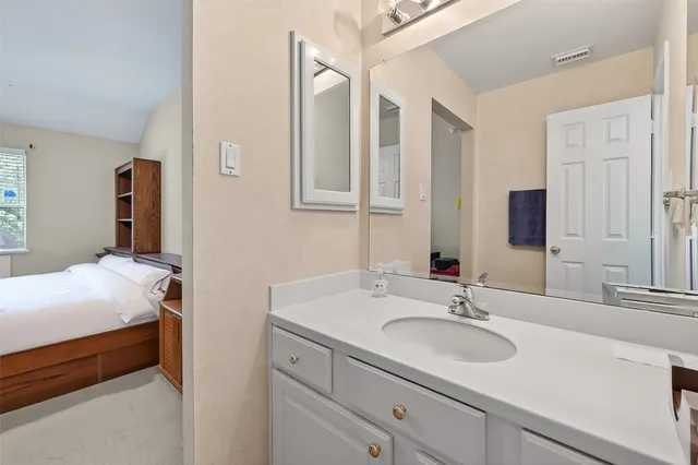 a en suite bathroom with a sink and a mirror