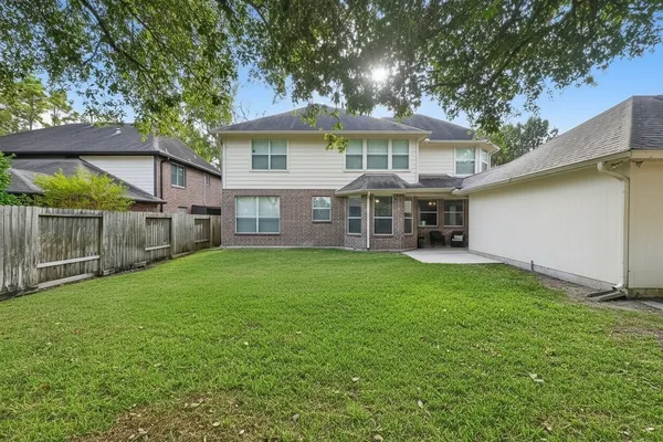 a view of a house with a yard and sitting area