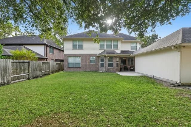 a view of a house with a yard and sitting area