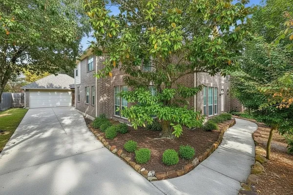 a front view of a house with garden