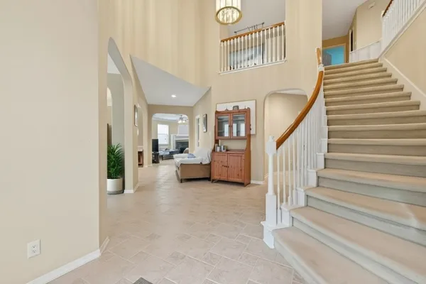 a view of staircase with lots of frames and a rug