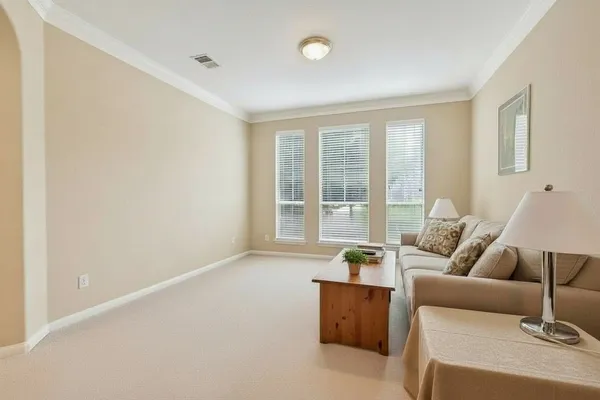 a living room with furniture and floor to ceiling windows