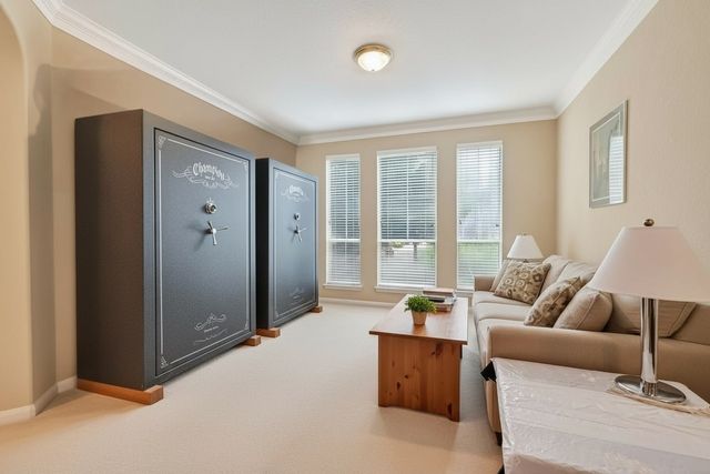 a living room with furniture and large windows