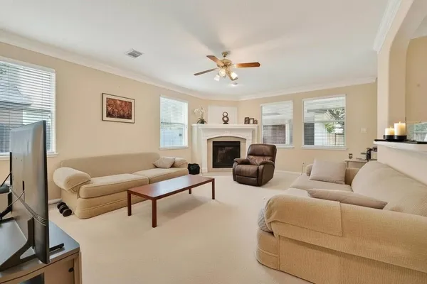 a living room with furniture a fireplace and a flat screen tv