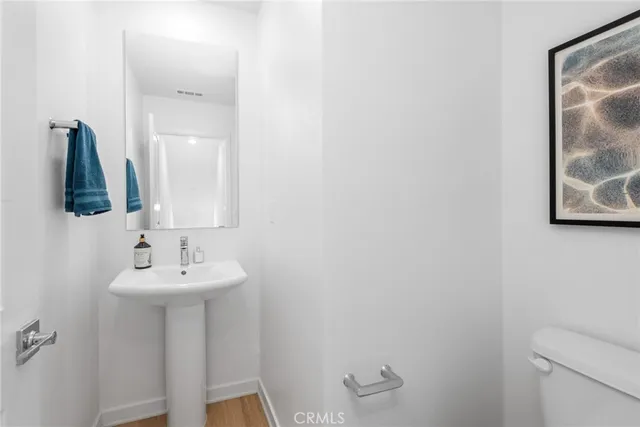 a bathroom with a sink toilet and mirror