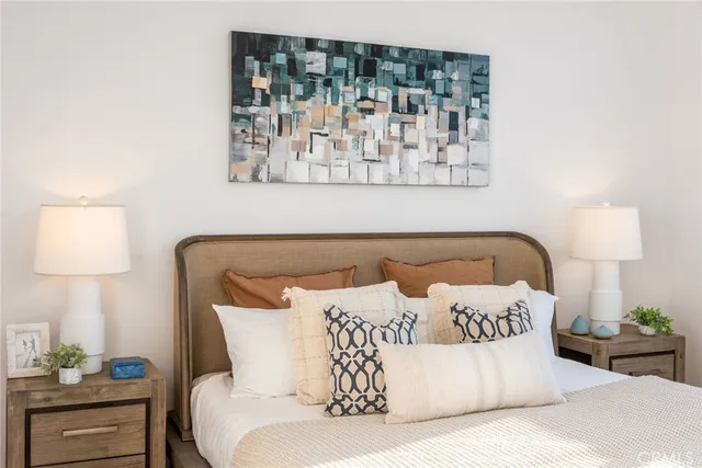 a bedroom with a bed and a painting on the wall