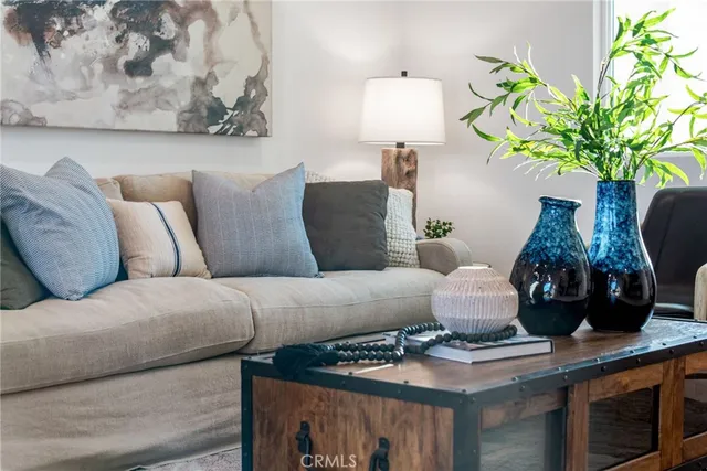 a living room with furniture flowerpot and wooden floor