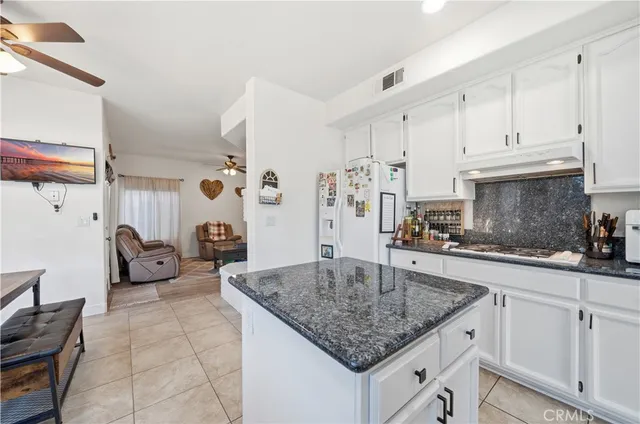 a kitchen with stainless steel appliances granite countertop a sink dishwasher and cabinets with wooden floor
