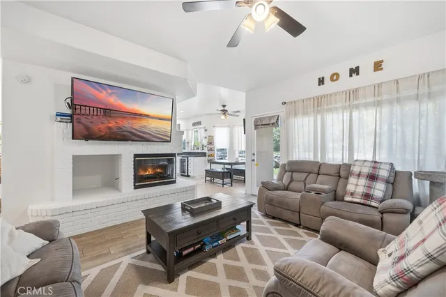 a living room with furniture a fireplace and a flat screen tv