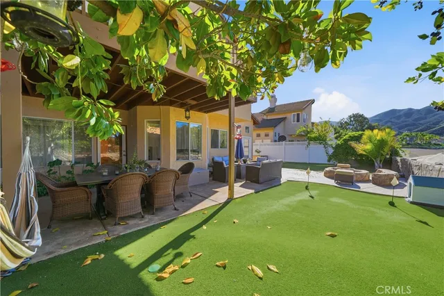 swimming pool with outdoor seating and a garden