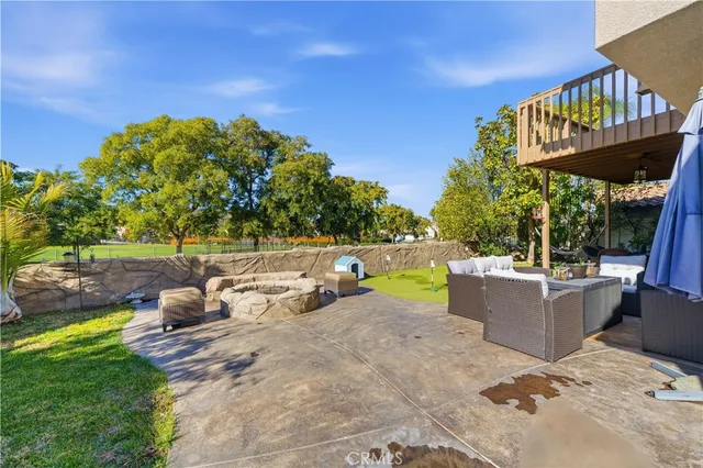 a view of a backyard with a tub and chairs
