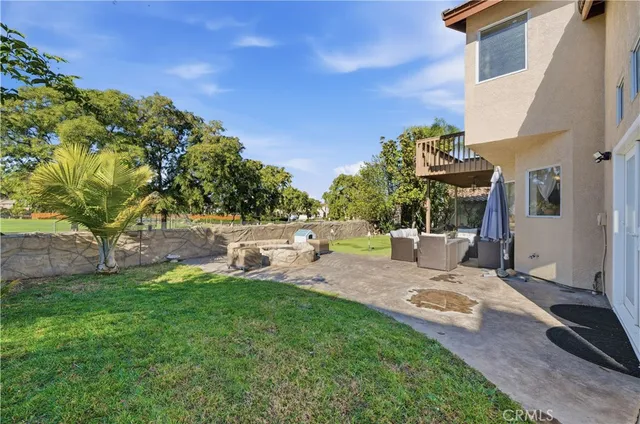 a view of backyard with swimming pool and sitting area