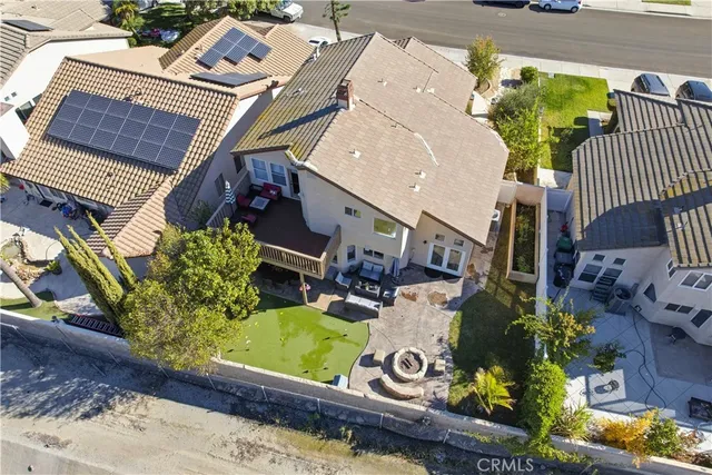 an aerial view of a house with a yard potted plants and large tree