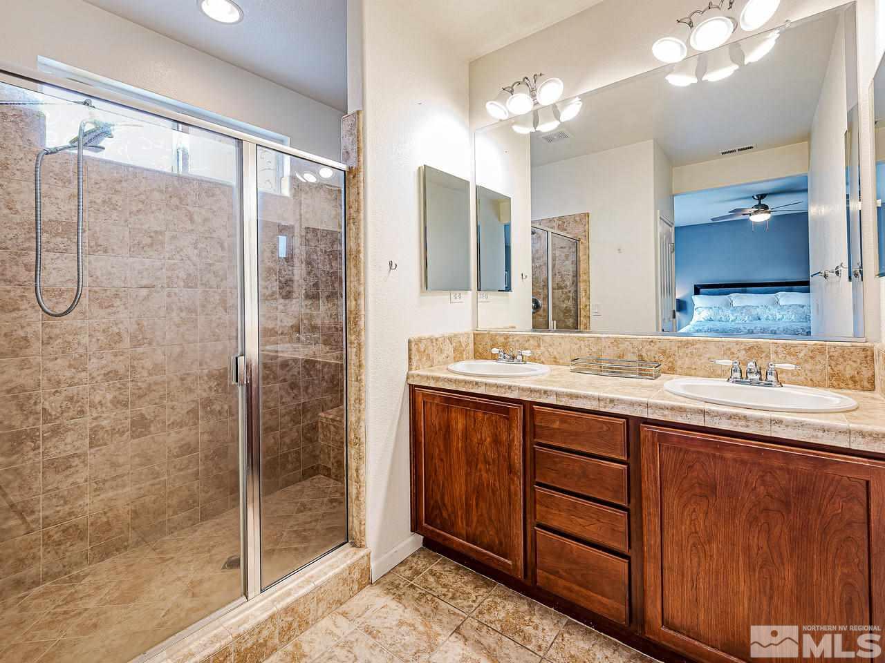 450 Alysheba Court Reno, NV 89521 - Photo 11 of 14 a bathroom with a double vanity sink mirror and shower