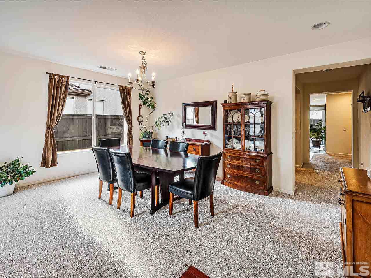 450 Alysheba Court Reno, NV 89521 - Photo 4 of 14 a view of a dining room with furniture and a chandelier