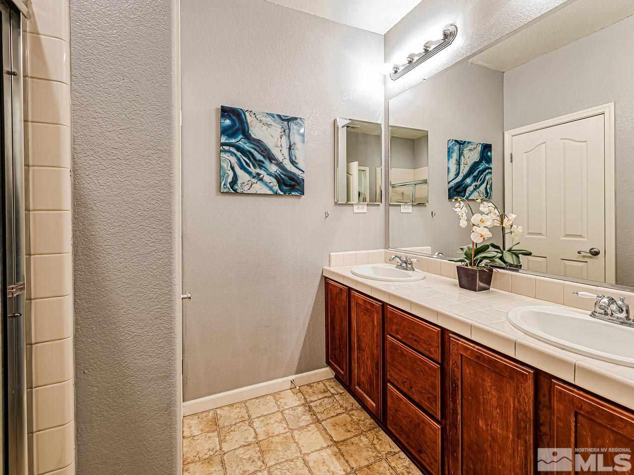 450 Alysheba Court Reno, NV 89521 - Photo 9 of 14 a spacious bathroom with a double vanity sink and a mirror