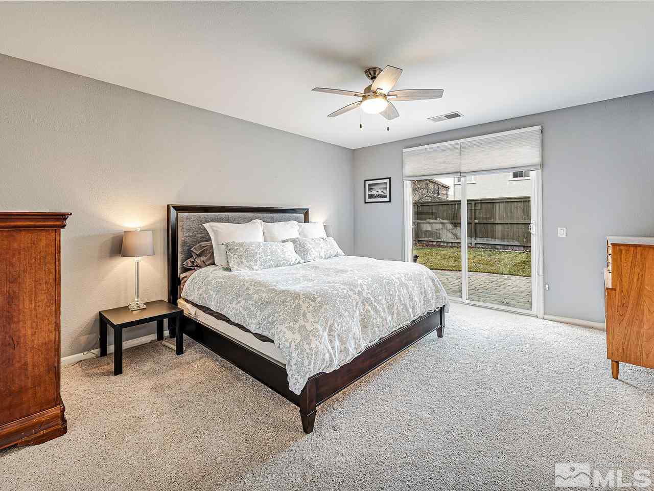 450 Alysheba Court Reno, NV 89521 - Photo 10 of 14 a bedroom with a large bed and a chandelier