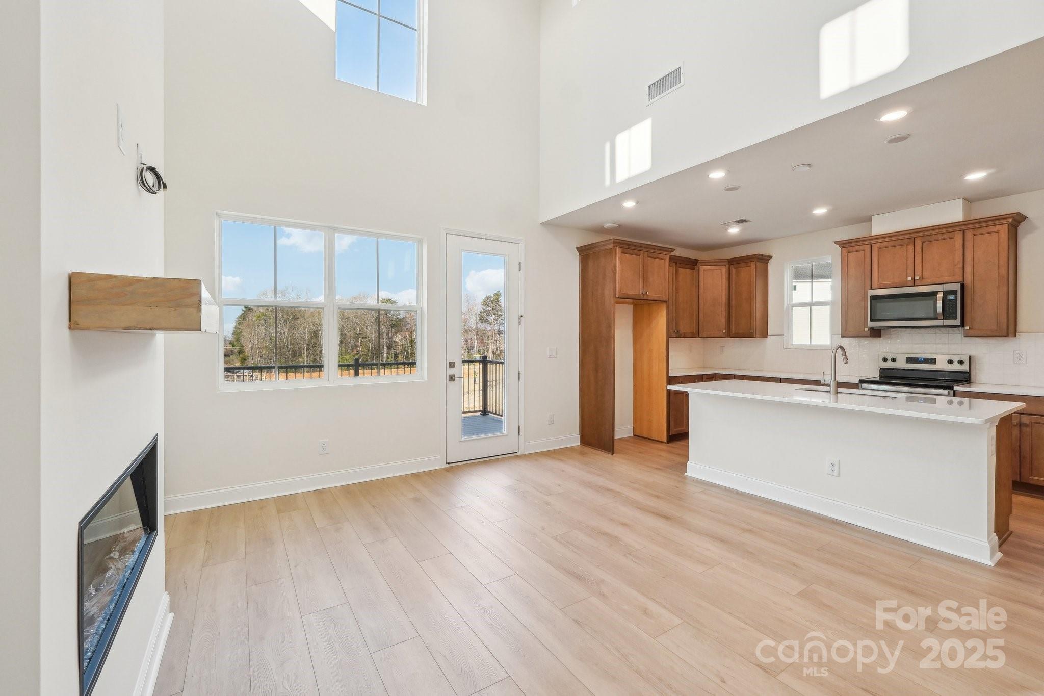 817 Terra Drive Tega Cay, SC 29708 - Photo 11 of 38 a view of a kitchen with a sink and microwave