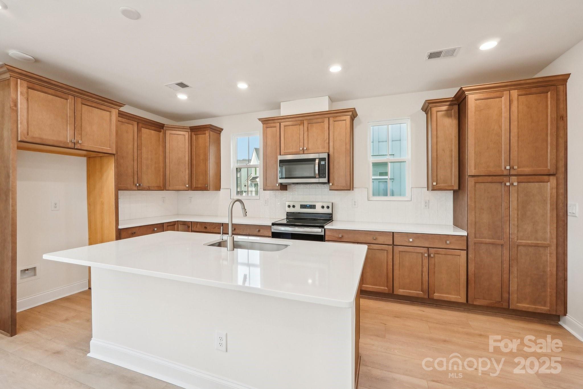 817 Terra Drive Tega Cay, SC 29708 - Photo 14 of 38 a kitchen with stainless steel appliances granite countertop a microwave a sink and a refrigerator