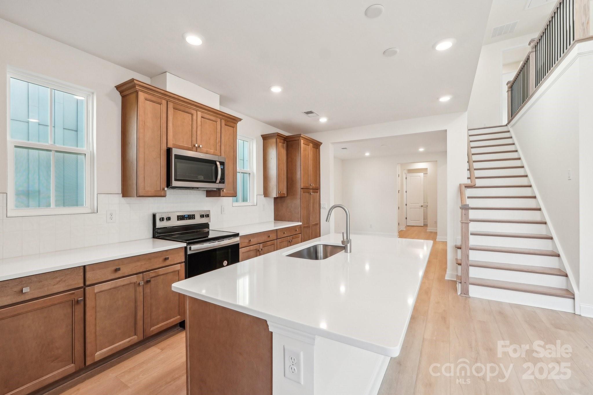 817 Terra Drive Tega Cay, SC 29708 - Photo 15 of 38 a kitchen with sink a microwave and cabinets