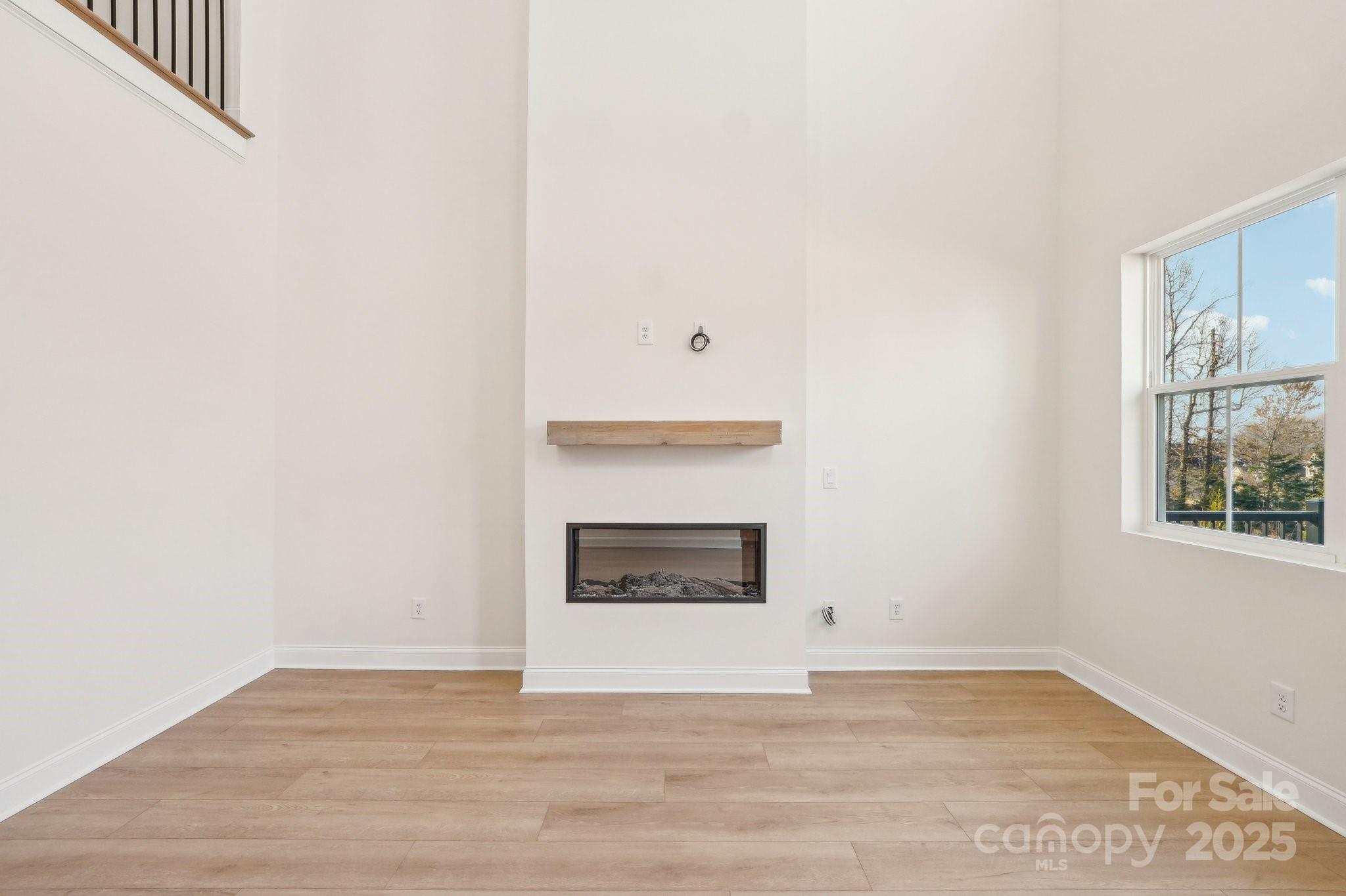 817 Terra Drive Tega Cay, SC 29708 - Photo 18 of 38 a view of an empty room with a fireplace and a window