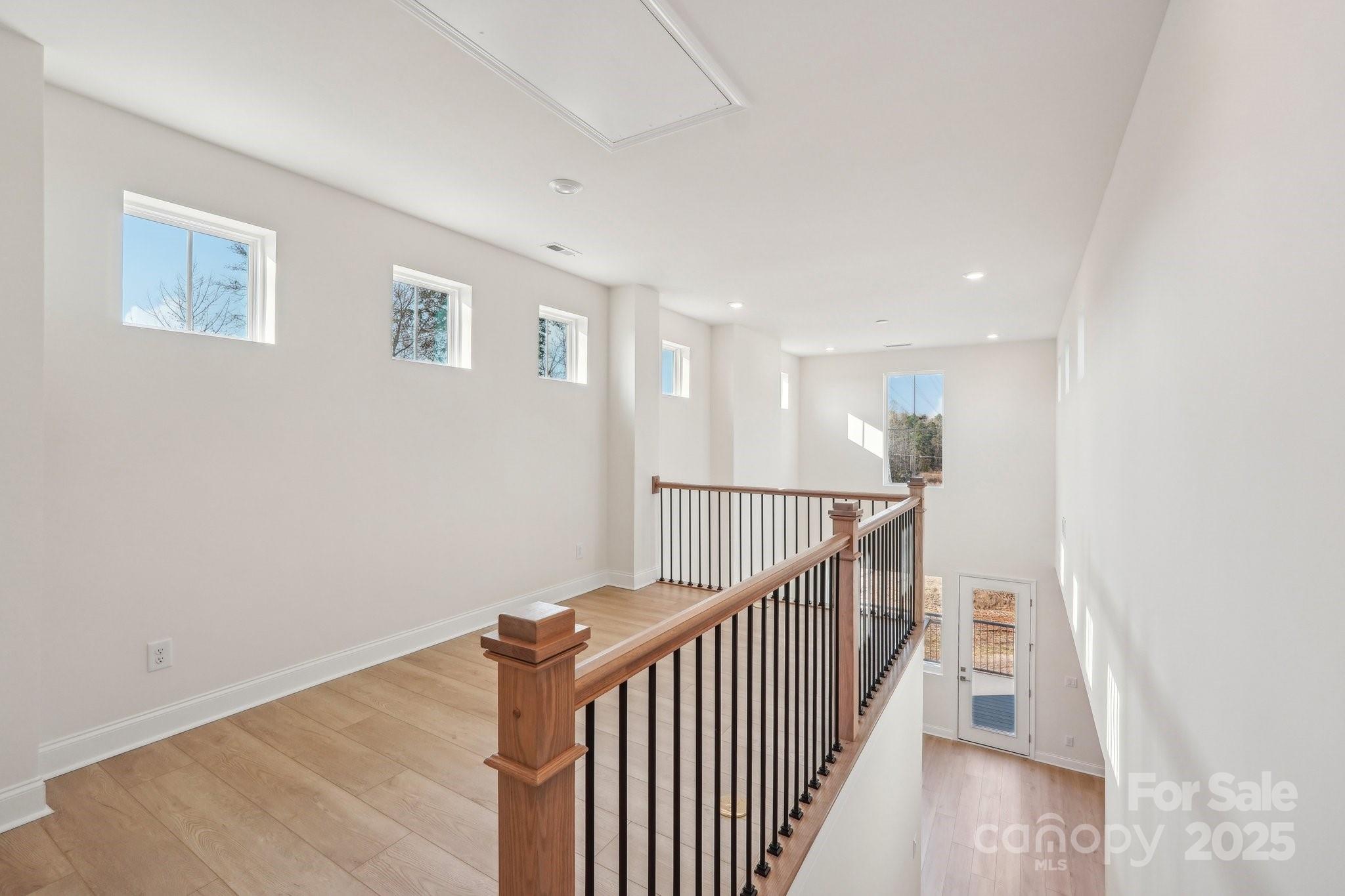 817 Terra Drive Tega Cay, SC 29708 - Photo 19 of 38 a view of a hallway with wooden floor and entryway
