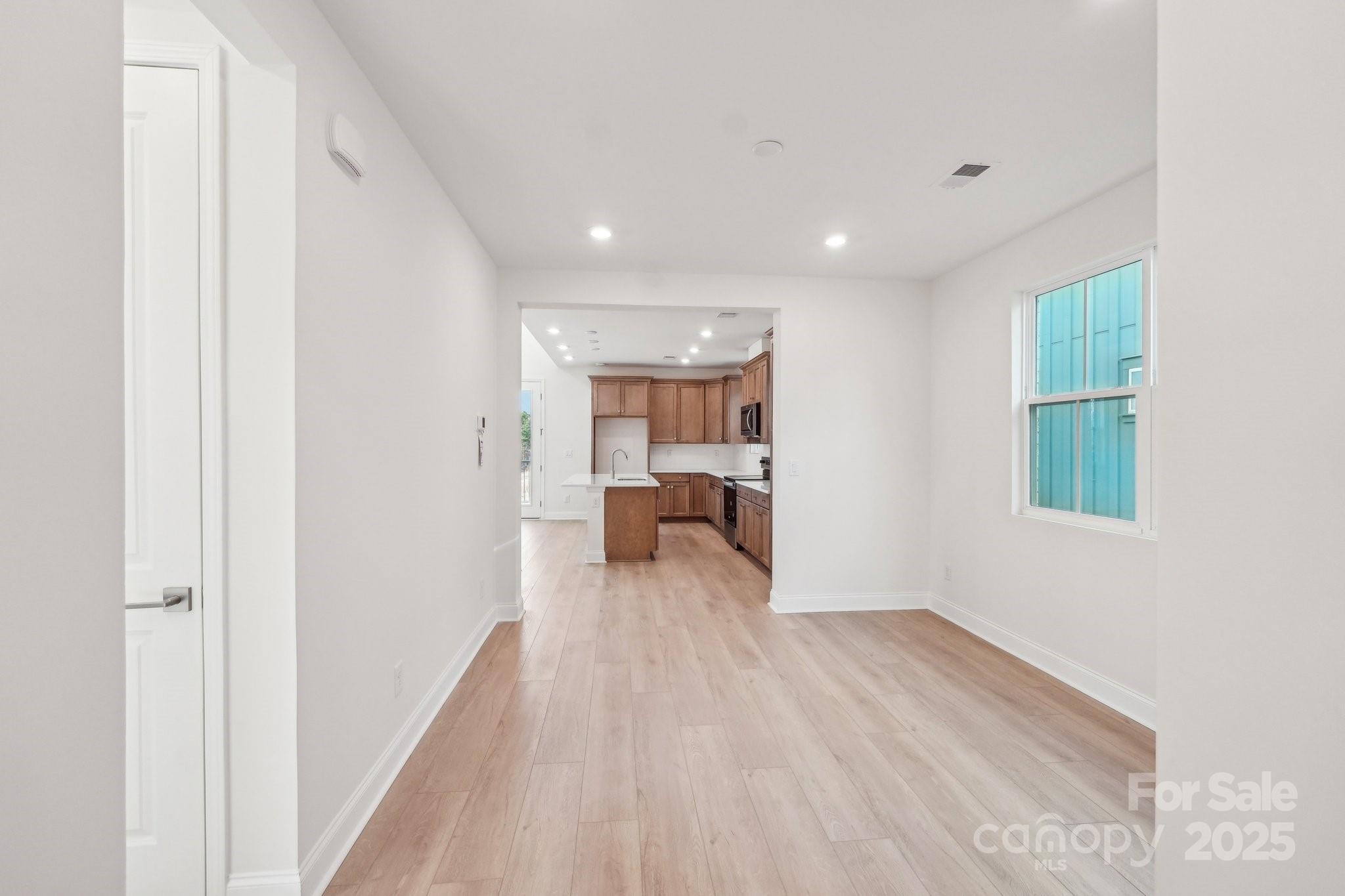 817 Terra Drive Tega Cay, SC 29708 - Photo 5 of 38 a view of a hallway with a bedroom and wooden floor
