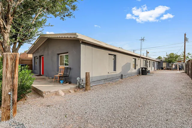 a view of a house with a patio and backyard