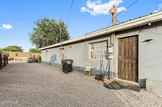 a view of a house with backyard and sitting area