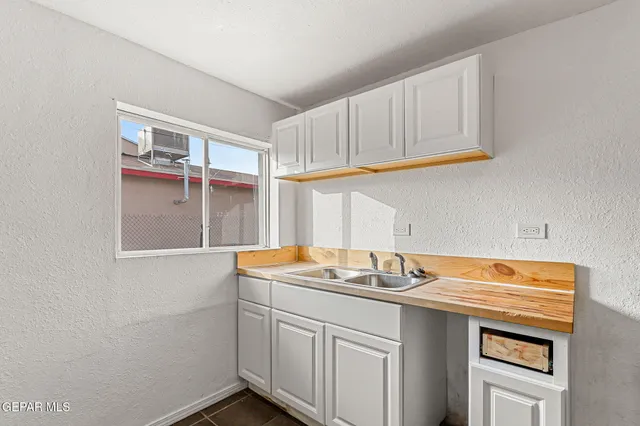 a kitchen with stainless steel appliances a sink and cabinets