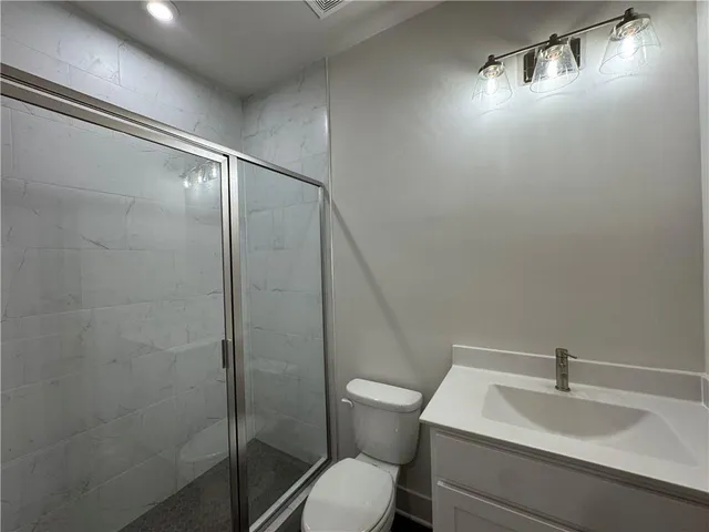 a white toilet sitting next to a bathroom sink