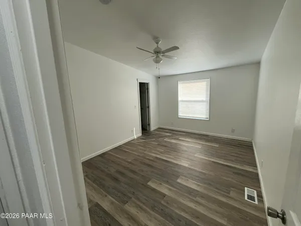 a view of a hallway with wooden floor and entryway