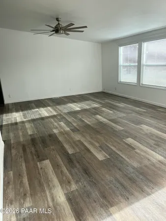 a view of a room with wooden floor and windows